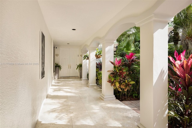 hallway with ornate columns and arched walkways