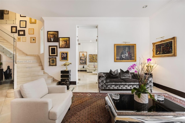 living area featuring crown molding, baseboards, and stairs