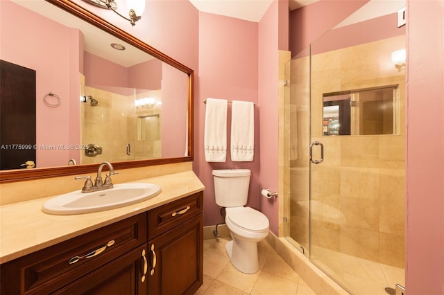 bathroom with vanity, tile patterned floors, a shower stall, and toilet