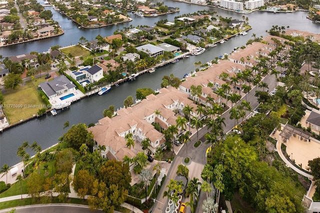 drone / aerial view featuring a residential view and a water view