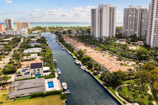 drone / aerial view featuring a view of city and a water view