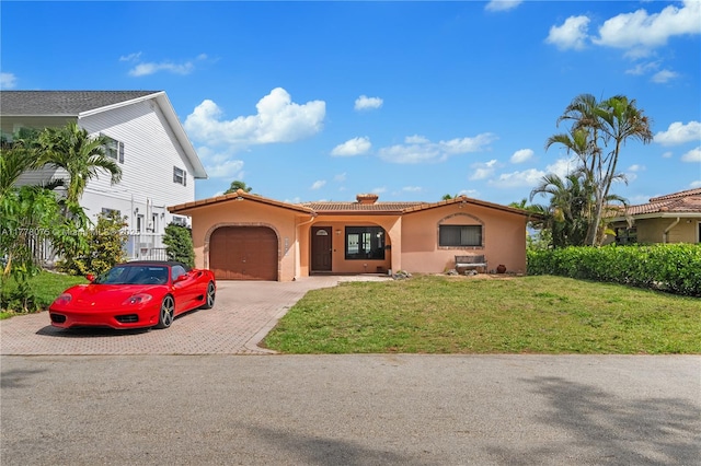 2447 SE 15th St, Pompano Beach, FL 33062 - mediterranean / spanish home with stucco siding, a front yard, a tile roof, a garage, and driveway