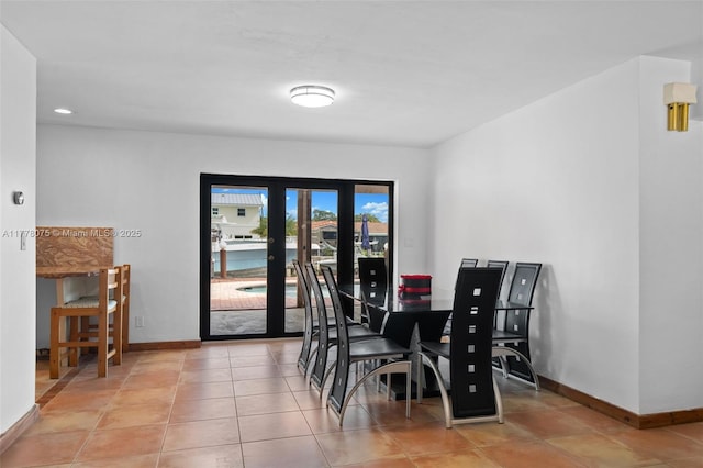 2447 SE 15th St, Pompano Beach, FL 33062 - dining area with french doors, light tile patterned floors, and baseboards