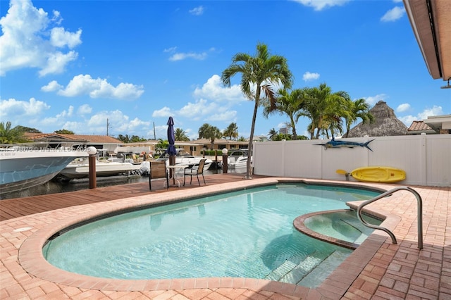 2447 SE 15th St, Pompano Beach, FL 33062 - view of swimming pool with a patio, a pool with connected hot tub, and fence