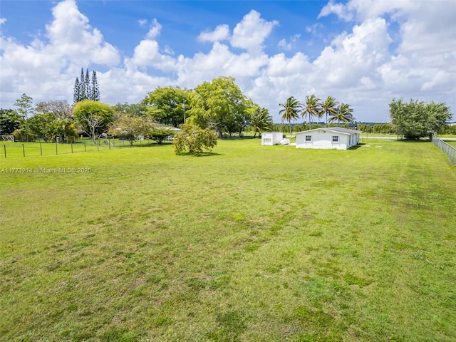 view of yard featuring fence and an outdoor structure