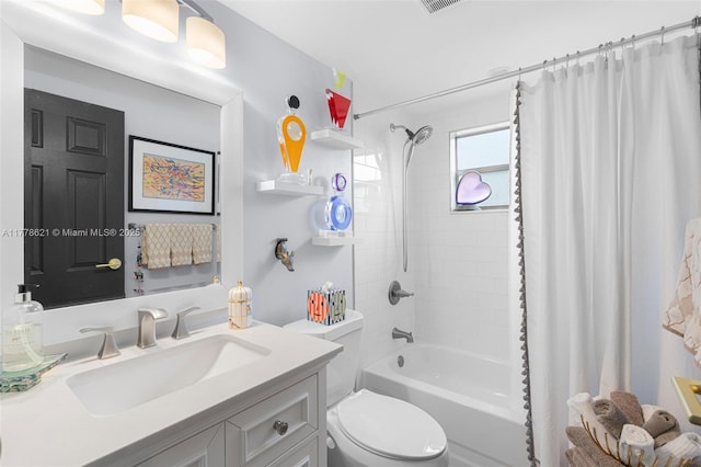 full bath featuring shower / bath combo with shower curtain, vanity, and toilet