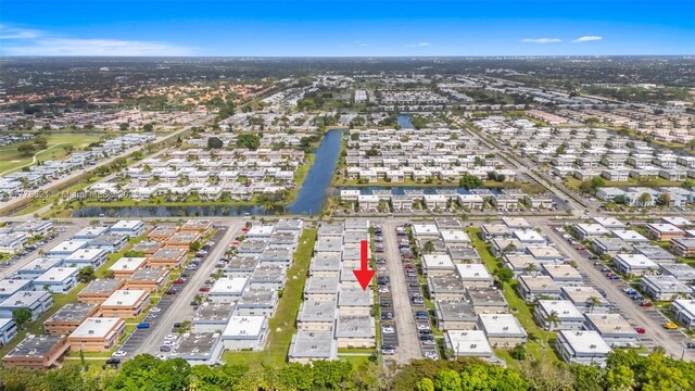 drone / aerial view featuring a residential view and a water view
