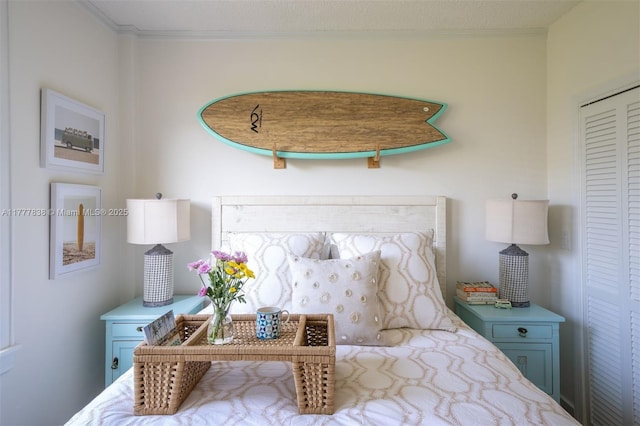 bedroom with crown molding and a closet