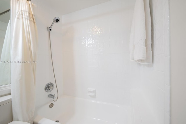 bathroom with shower / tub combo and toilet