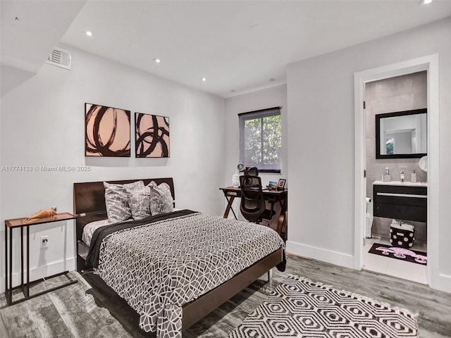 1273 NE 92nd St, Miami Shores, FL 33138 - bedroom featuring wood finished floors, recessed lighting, baseboards, and connected bathroom