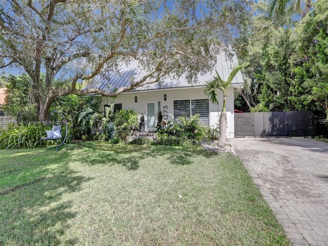 1273 NE 92nd St, Miami Shores, FL 33138 - view of front of property with a gate, decorative driveway, and stucco siding