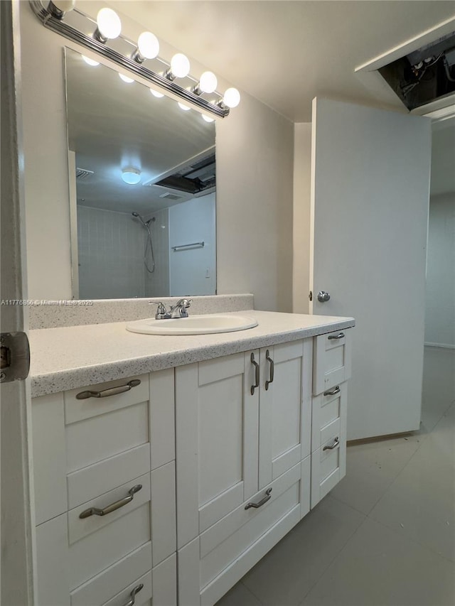 full bath with a shower, tile patterned flooring, and vanity