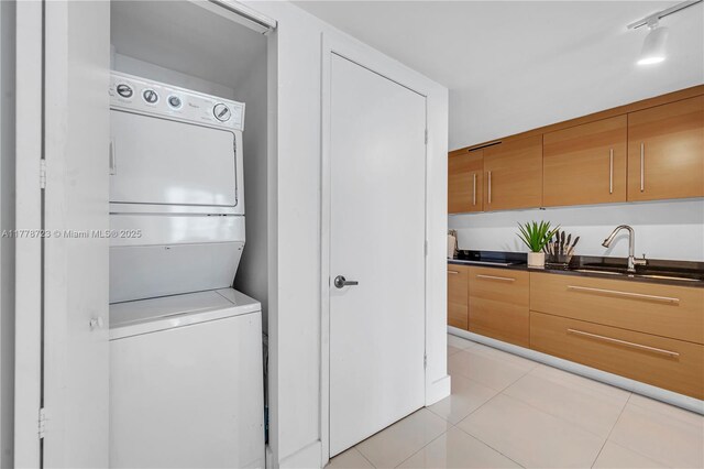 485 SE Brickell Ave Unit 1711, Miami, FL 33131 - laundry area with stacked washer and clothes dryer and light tile patterned floors