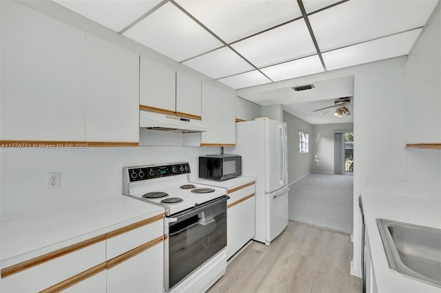 12701 SW 13th St Unit 301F, Pembroke Pines, FL 33027 - kitchen with white appliances, light countertops, under cabinet range hood, visible vents, and light wood finished floors