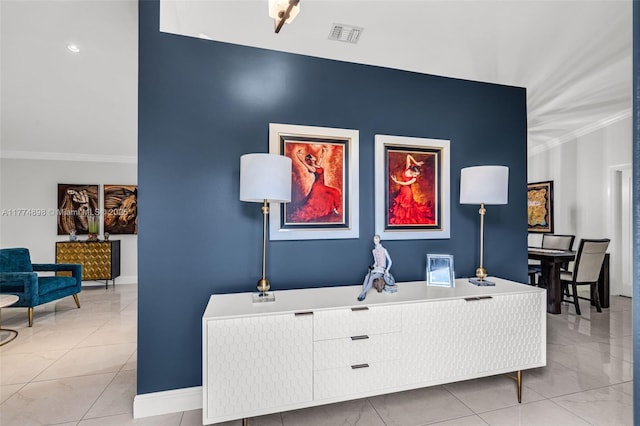 interior space with crown molding, baseboards, and visible vents