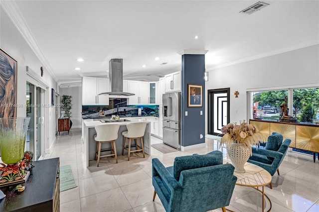 living room with light tile patterned floors, ornamental molding, visible vents, recessed lighting, and baseboards