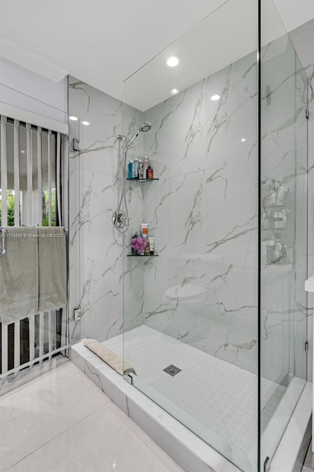 full bath featuring a marble finish shower, stone wall, and recessed lighting