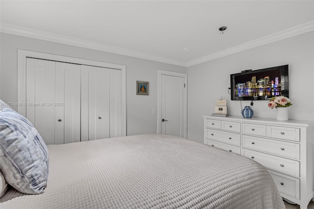 bedroom featuring ornamental molding and a closet