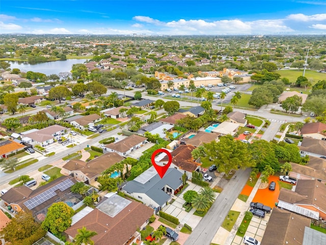drone / aerial view with a water view and a residential view