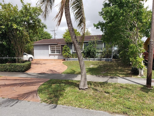 10041 SW 14th Ter, Miami, FL 33174 - ranch-style house featuring stucco siding, a tile roof, a front yard, and driveway