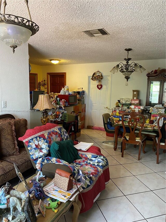 10041 SW 14th Ter, Miami, FL 33174 - dining space featuring tile patterned flooring, a textured ceiling, and a chandelier