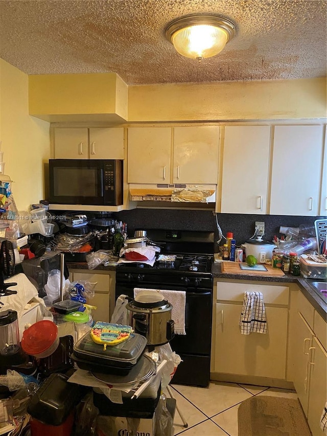 10041 SW 14th Ter, Miami, FL 33174 - kitchen with black appliances, under cabinet range hood, light tile patterned floors, white cabinetry, and a textured ceiling
