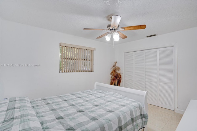 10610 SW 203rd Ter, Cutler Bay, FL 33189 - bedroom featuring a textured ceiling, visible vents, ceiling fan, and a closet