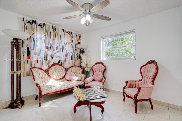 10610 SW 203rd Ter, Cutler Bay, FL 33189 - living area with tile patterned flooring, a textured ceiling, and a ceiling fan