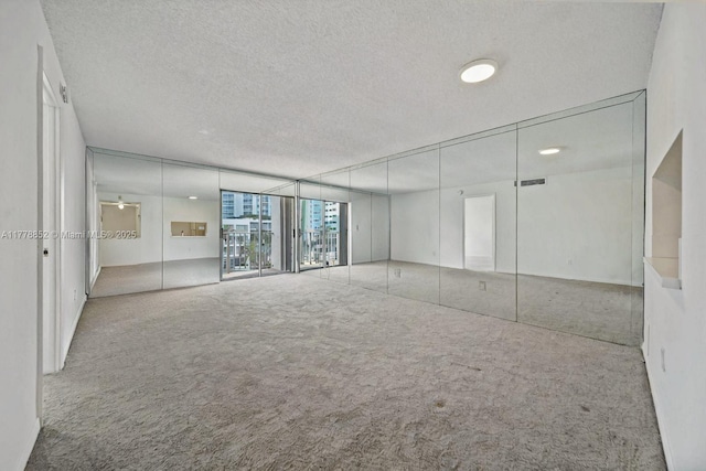 6545 Indian Creek Dr Unit 505, Miami Beach, FL 33141 - unfurnished room featuring carpet flooring and a textured ceiling