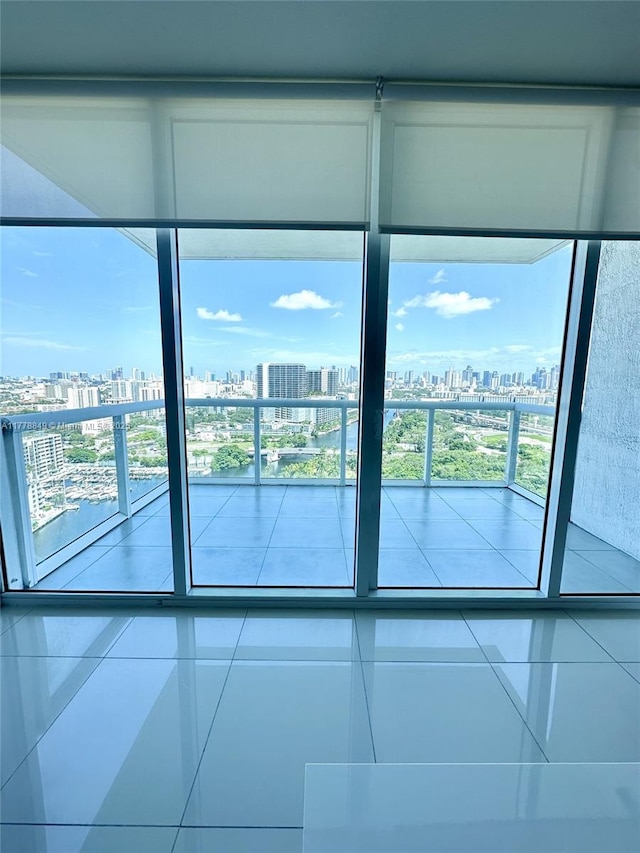 empty room featuring a city view and tile patterned floors