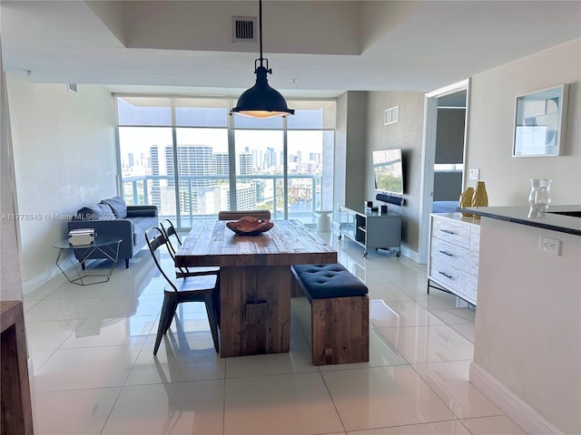 dining room with light tile patterned floors, baseboards, and visible vents
