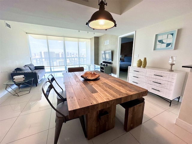 dining area with light tile patterned flooring, baseboards, and visible vents