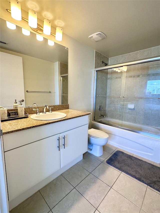 full bath with vanity, visible vents, toilet, bath / shower combo with glass door, and tile patterned floors