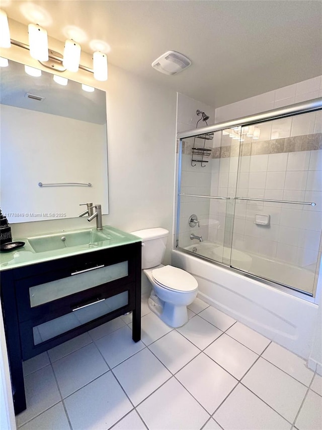 bathroom featuring vanity, enclosed tub / shower combo, tile patterned floors, toilet, and visible vents