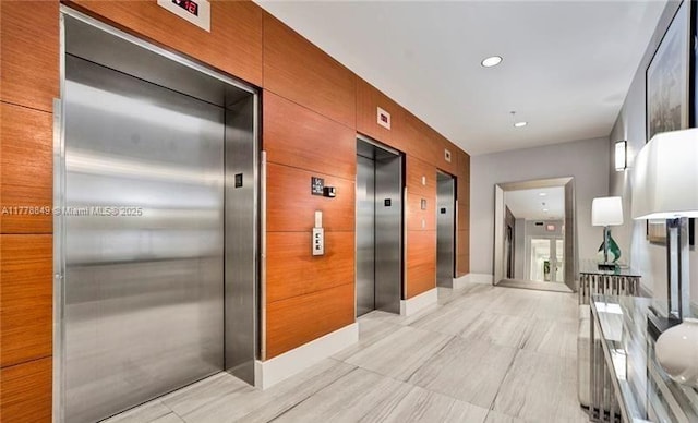 corridor featuring elevator and recessed lighting