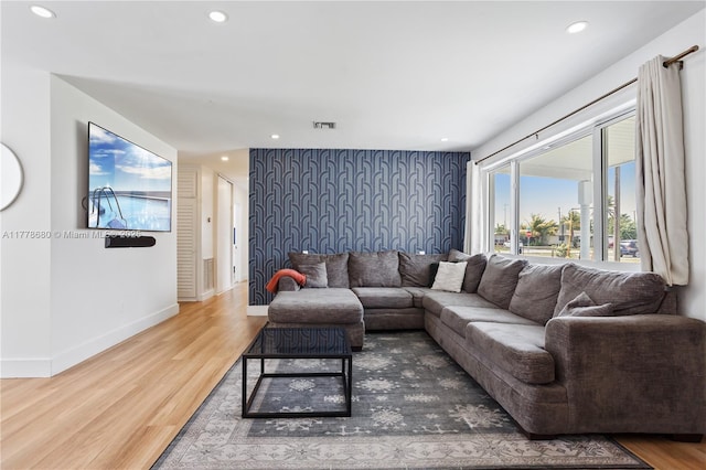 living area featuring wood finished floors, recessed lighting, and baseboards