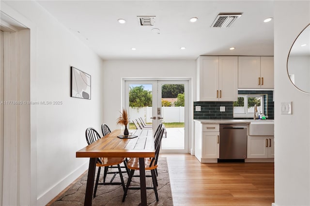 dining room featuring recessed lighting, light wood-style flooring, baseboards, visible vents, and french doors