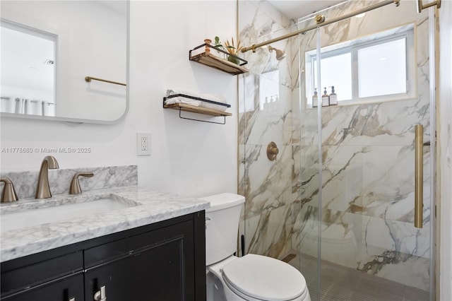 full bathroom featuring a marble finish shower, toilet, and vanity