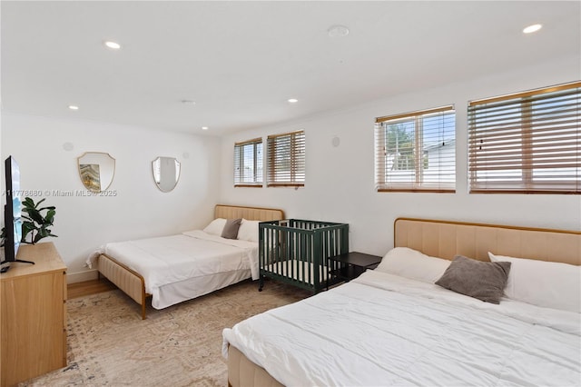 bedroom featuring recessed lighting, wood finished floors, multiple windows, and crown molding