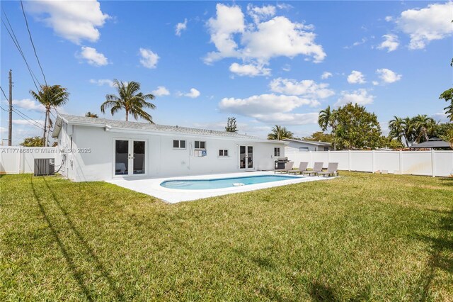 3710 NW 6th Ave, Deerfield Beach, FL 33064 - back of property with french doors, stucco siding, central AC unit, and a patio