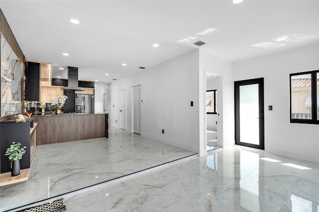 interior space with visible vents, modern cabinets, open floor plan, island exhaust hood, and marble finish floor