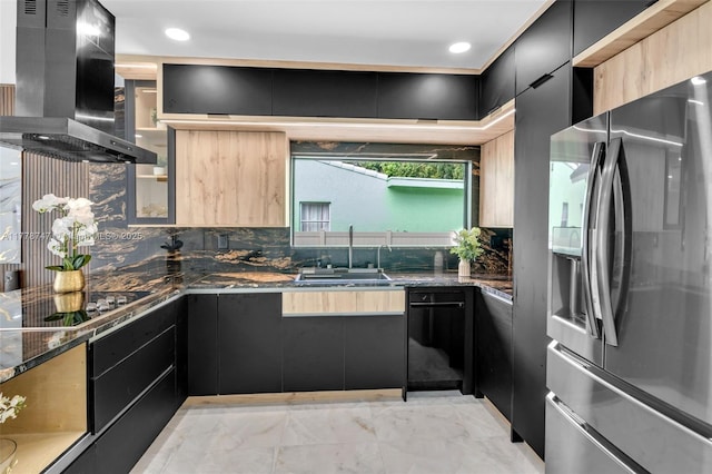 kitchen featuring stainless steel refrigerator with ice dispenser, black electric cooktop, a sink, dark cabinetry, and island exhaust hood