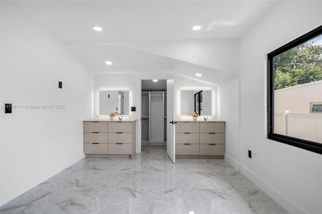 bathroom featuring recessed lighting, two vanities, marble finish floor, and lofted ceiling