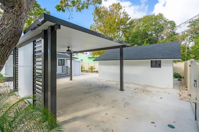 view of patio / terrace featuring an outbuilding and fence