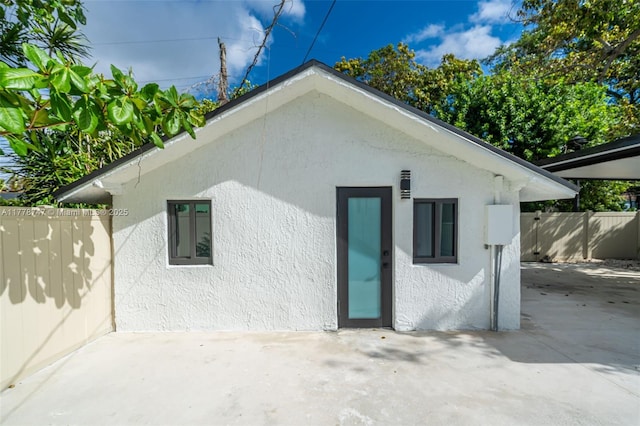 exterior space featuring a patio area and stucco siding