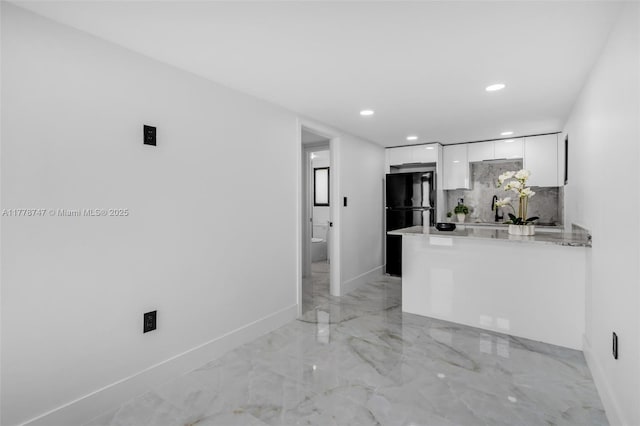 unfurnished living room with a sink, baseboards, recessed lighting, and marble finish floor