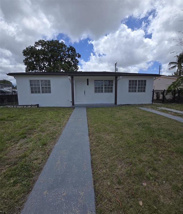 3242 NW 87th Ter, Miami, FL 33147 - ranch-style home featuring a front yard, fence, and stucco siding