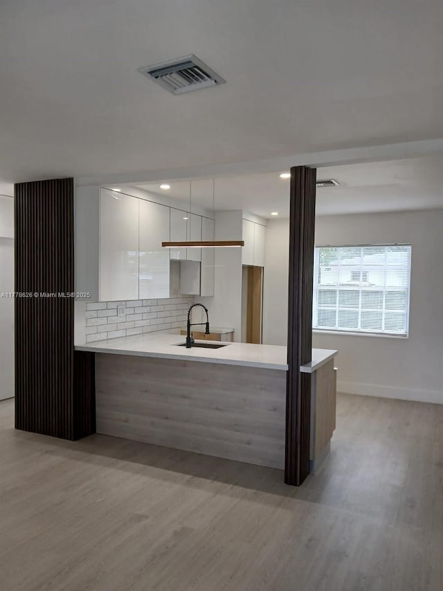 3242 NW 87th Ter, Miami, FL 33147 - kitchen with white cabinetry, visible vents, modern cabinets, light wood finished floors, and a sink