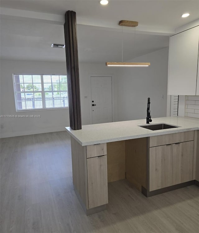 3242 NW 87th Ter, Miami, FL 33147 - kitchen featuring modern cabinets, light wood-type flooring, recessed lighting, a sink, and light brown cabinets