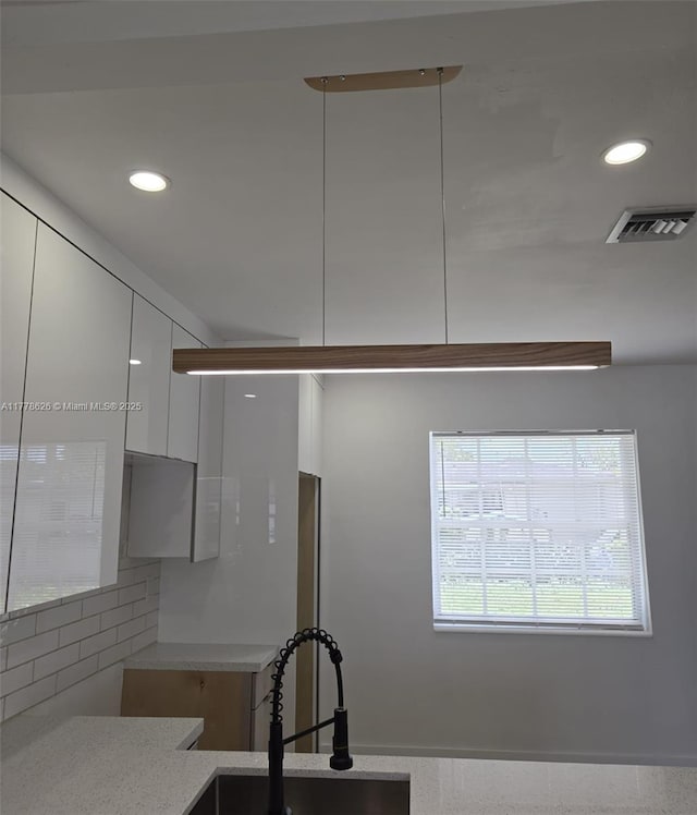3242 NW 87th Ter, Miami, FL 33147 - kitchen with recessed lighting, white cabinets, visible vents, modern cabinets, and a sink